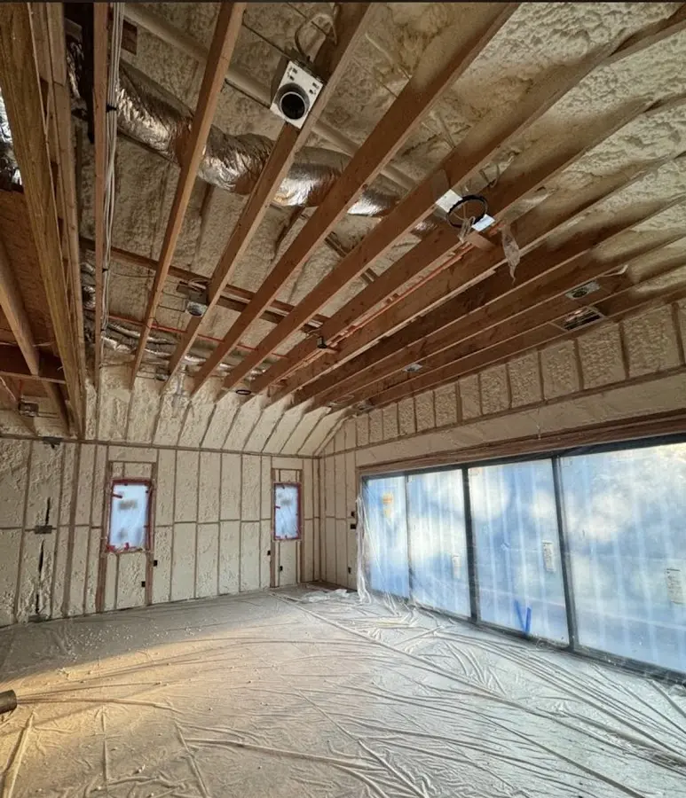 Interior walls and ceiling insulated with spray foam during new construction in Dedham